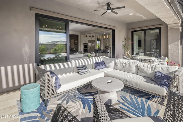 view of patio with an outdoor living space and ceiling fan