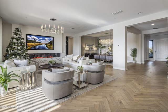 living room with parquet flooring, a fireplace, and a chandelier