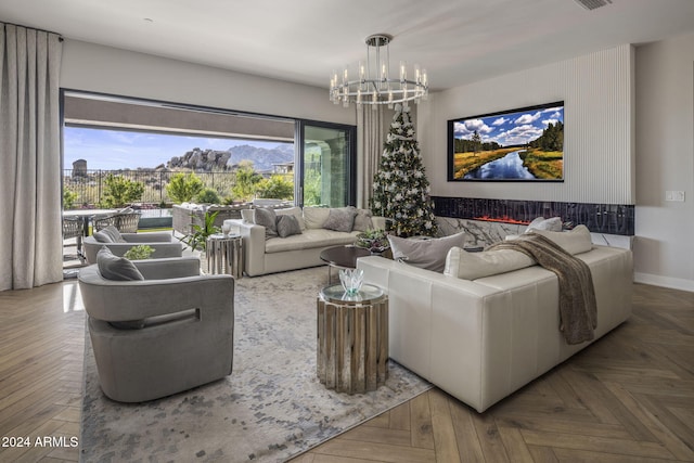 living room featuring parquet flooring, a chandelier, and a healthy amount of sunlight