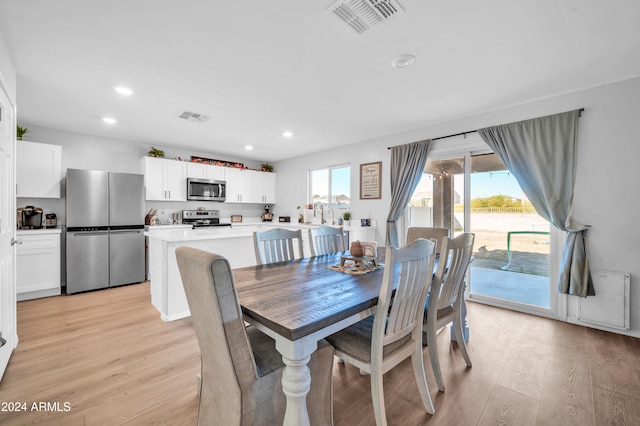 dining space with light wood-type flooring