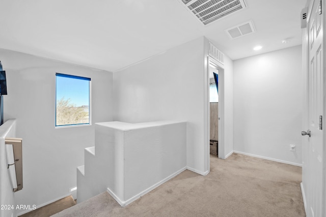 corridor with light colored carpet