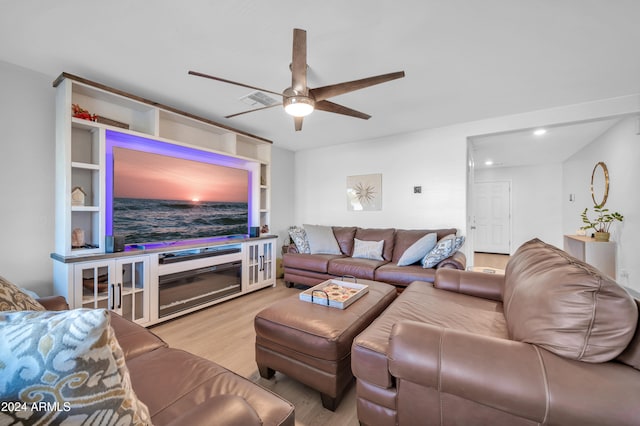 living room featuring light hardwood / wood-style floors and ceiling fan