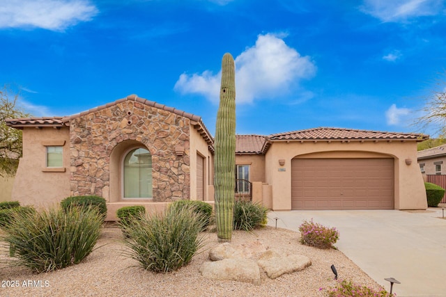 8367 W Lariat Ln, Peoria, AZ 85383 - mediterranean / spanish-style home with a tile roof, concrete driveway, a garage, and stucco siding