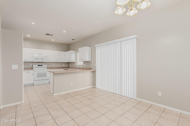 kitchen with light tile patterned flooring, white appliances, a notable chandelier, kitchen peninsula, and white cabinetry