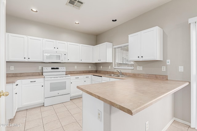 kitchen with white appliances, sink, light tile patterned flooring, kitchen peninsula, and white cabinetry