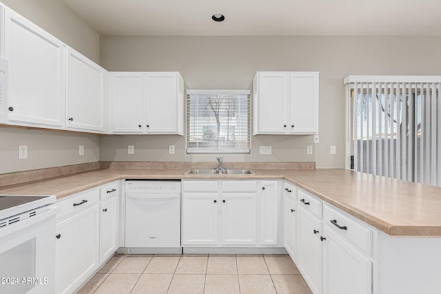 kitchen featuring white cabinets, kitchen peninsula, sink, and white appliances