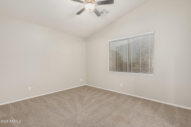 spare room featuring ceiling fan, vaulted ceiling, and carpet flooring