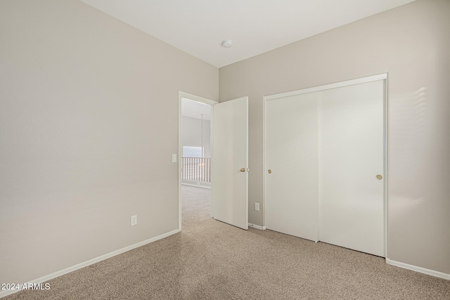 unfurnished bedroom featuring a closet and carpet flooring