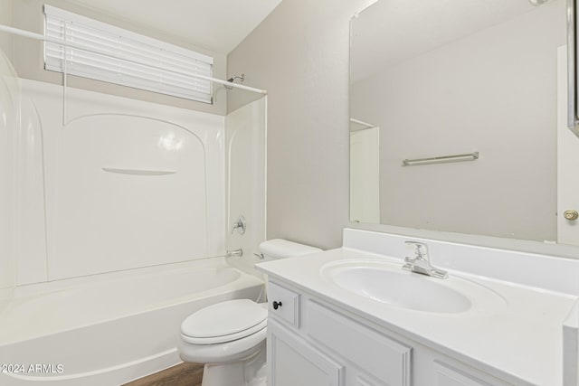 full bathroom with hardwood / wood-style flooring, vanity, shower / bathtub combination, and toilet