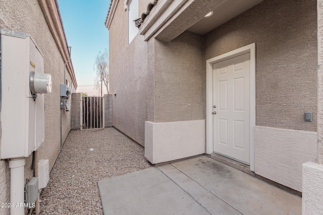 exterior entry at dusk featuring a patio