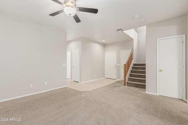 unfurnished living room with light colored carpet and ceiling fan