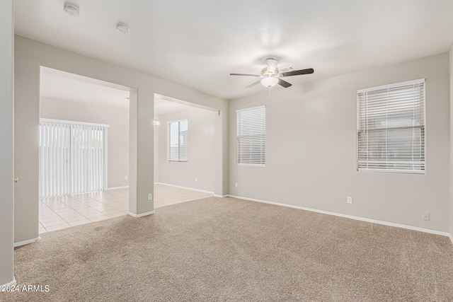 carpeted empty room featuring ceiling fan