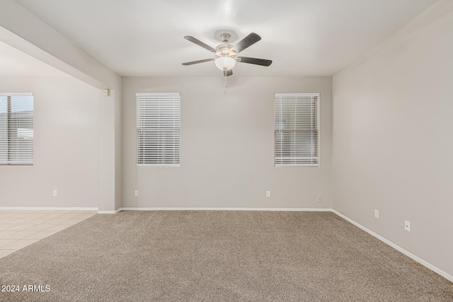 carpeted empty room with ceiling fan