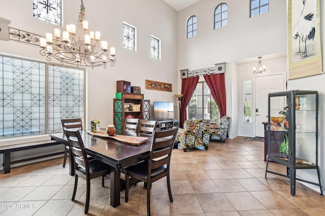 tiled dining room featuring a high ceiling and a notable chandelier