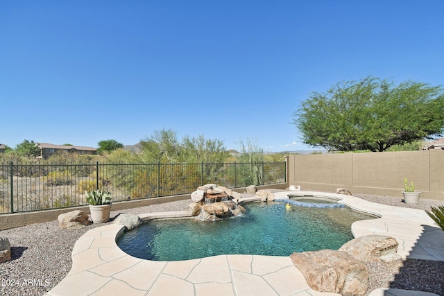 view of swimming pool with an in ground hot tub, pool water feature, and a patio area