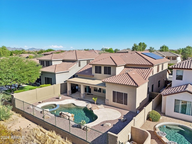 view of swimming pool featuring a patio and an in ground hot tub