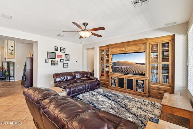 tiled living room with ceiling fan