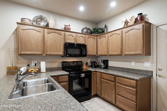 kitchen featuring sink, light tile patterned floors, and black appliances