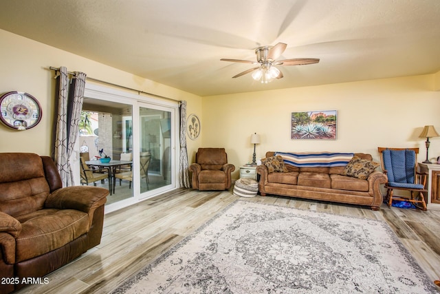 living room with a ceiling fan and wood finished floors