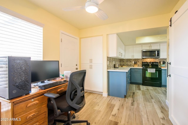 office area featuring a ceiling fan and light wood finished floors