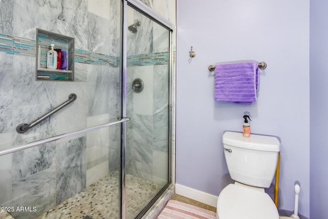 full bath featuring a shower stall, toilet, and baseboards