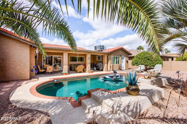 view of swimming pool with a patio, central AC unit, a fenced backyard, and a fenced in pool