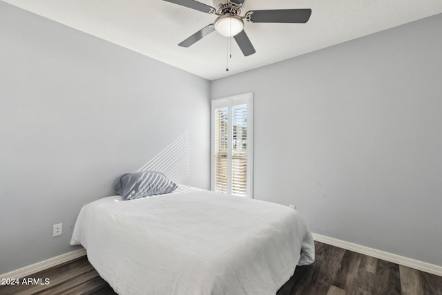 bedroom featuring ceiling fan and dark hardwood / wood-style floors