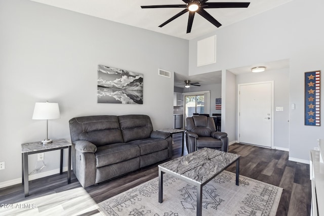 living room featuring a high ceiling and hardwood / wood-style flooring