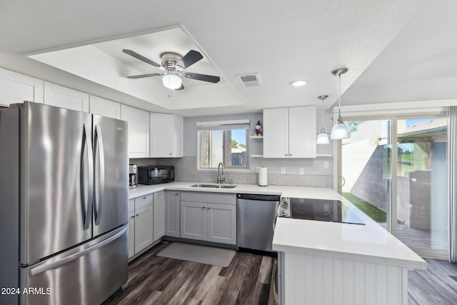 kitchen featuring sink, white cabinets, black appliances, and dark hardwood / wood-style floors