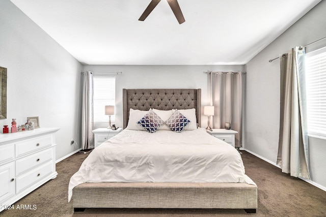 bedroom with dark colored carpet and ceiling fan