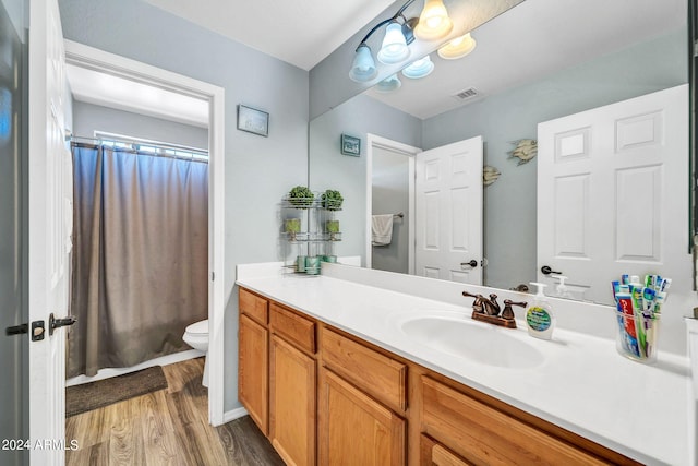 bathroom with hardwood / wood-style floors, vanity, toilet, and a shower with shower curtain