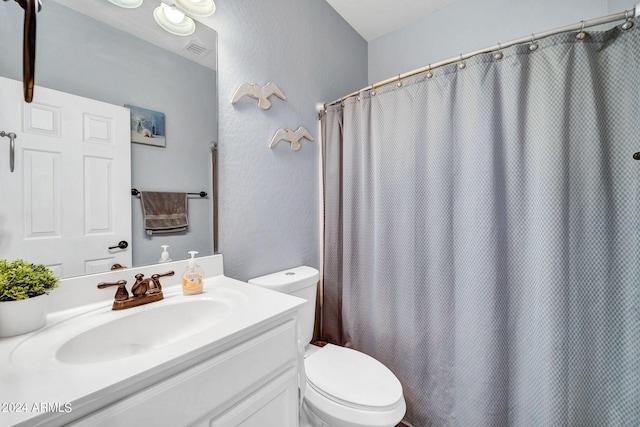 bathroom featuring vanity, toilet, and a shower with shower curtain