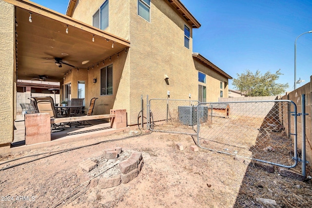 back of property with ceiling fan and a patio area