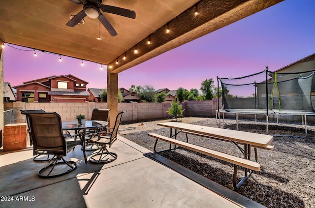 patio terrace at dusk with a trampoline and ceiling fan