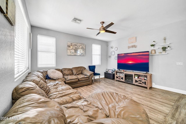 living room featuring ceiling fan and hardwood / wood-style flooring