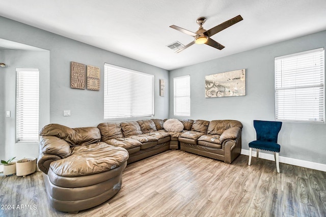 living room featuring ceiling fan, light hardwood / wood-style flooring, and a healthy amount of sunlight