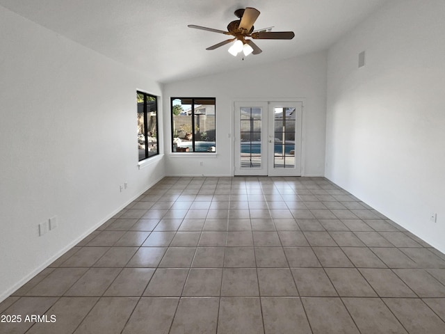 spare room featuring ceiling fan, vaulted ceiling, light tile patterned floors, and french doors