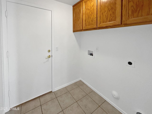 laundry room with washer hookup, electric dryer hookup, light tile patterned flooring, and cabinets