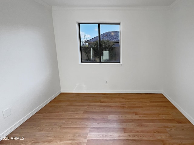 unfurnished room with light wood-type flooring and ornamental molding