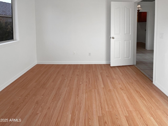 empty room with light hardwood / wood-style flooring