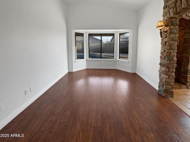 spare room featuring dark wood-type flooring