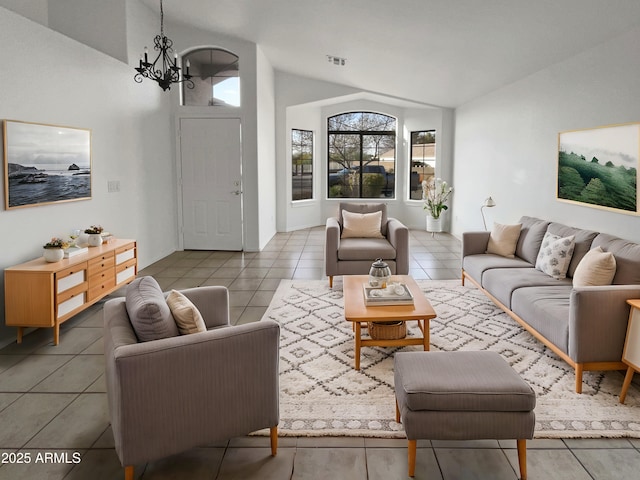 living room with tile patterned floors, lofted ceiling, and a chandelier