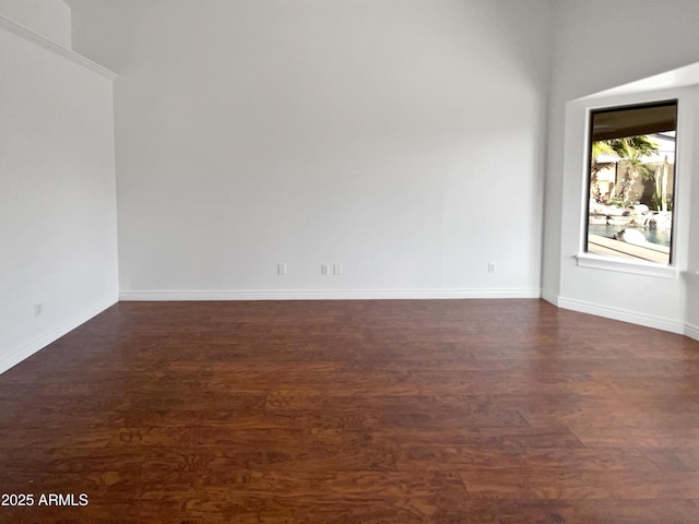 spare room with dark wood-type flooring