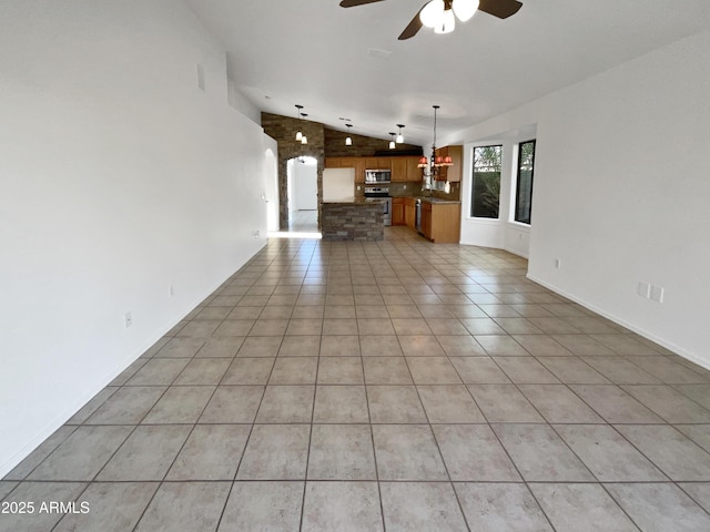 unfurnished living room with ceiling fan, light tile patterned floors, and lofted ceiling