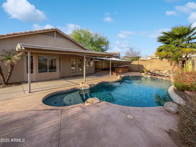 view of pool featuring a patio area and french doors