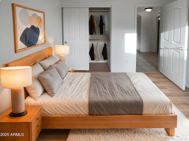 bedroom with a closet and light wood-type flooring