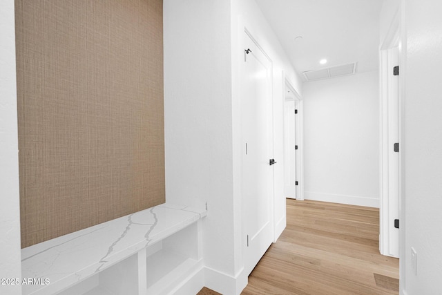 hall with light wood-type flooring, baseboards, visible vents, and recessed lighting