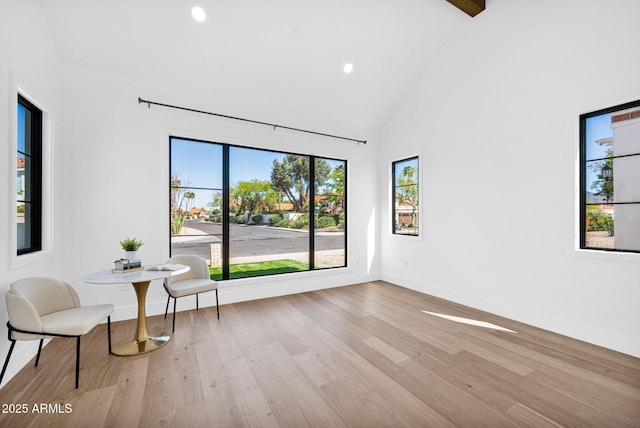 living area featuring recessed lighting, baseboards, high vaulted ceiling, and wood finished floors