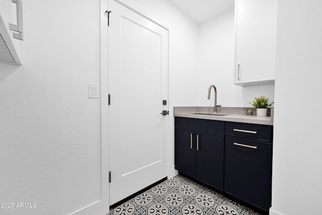 bar with light tile patterned flooring and a sink