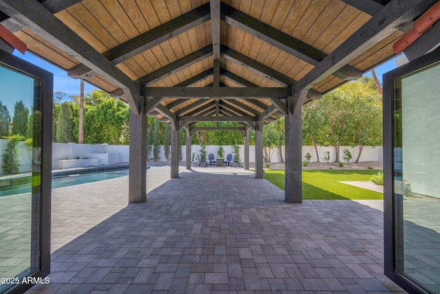 view of patio with a gazebo, a fenced backyard, and a fenced in pool